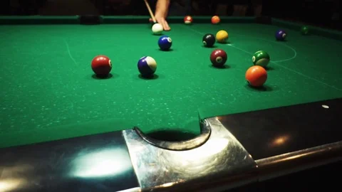 Playing billiards, blowing a cue on the ball, the ball hit the pocket, the ball Stock Footage 77281914