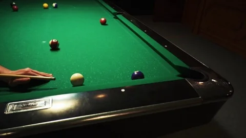 Playing billiards, blowing a cue on the ball, the ball hit the pocket, the ball Stock Footage 77282010