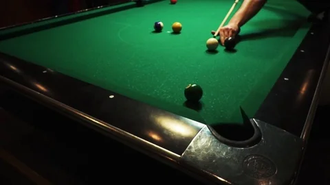 Playing billiards, blowing a cue on the ball, the ball hit the pocket, the ball Stock Footage 77282090