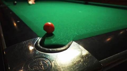 Playing billiards, blowing a cue on the ball, the ball hit the pocket, the ball Stock Footage 77282583