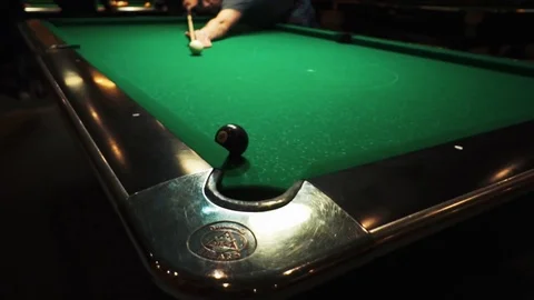 Playing billiards, blowing a cue on the ball, the ball hit the pocket, the ball Stock Footage 77282788