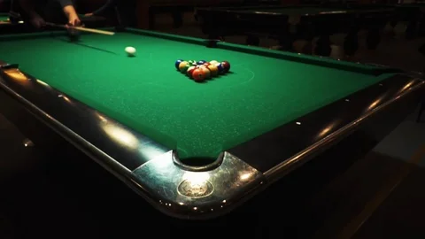 Playing billiards, blowing a cue on the ball, the ball hit the pocket, the ball Stock Footage 77283158