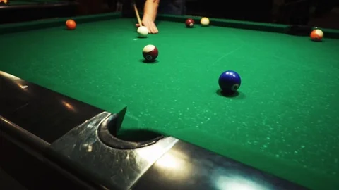 Playing billiards, blowing a cue on the ball, the ball hit the pocket, the ball Stock Footage 77283201