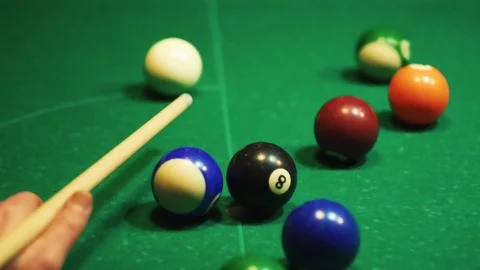 Playing billiards, blowing a cue on the ball, the ball hit the pocket, the ball Stock Footage 77283539