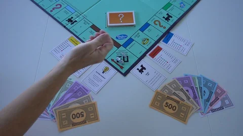 Playing the board game Monopoly.  Concept business and finance. Stock Footage 121692640