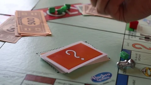 Playing The Board Game Monopoly. Rolling Dice Video stock 125052487