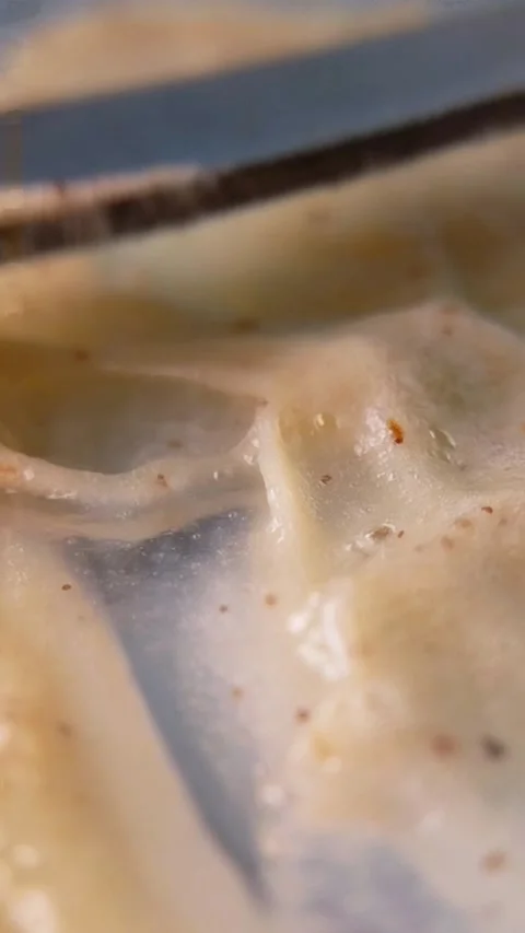 Playing with brown cream using a metal tool. Showing elastic and chewy text.. Stock Footage 336238600
