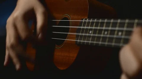 Playing brown ukulele Stock Footage 72407945