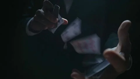 Playing card flies from hand to hand in close-up Stock Footage 180374196