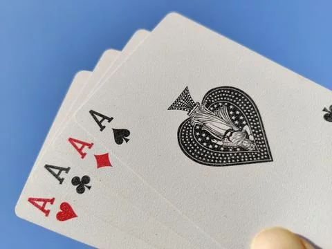 Playing Cards all aces, holding in hand or fingers against the sky Stock Photos
