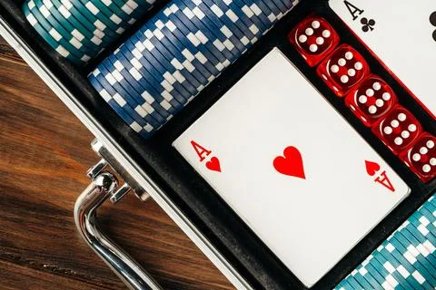 Playing cards and chips in a case on wooden table Stock Photos