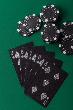 Playing cards and chips on a green cloth, a gambling game of poker. Cards a.. Stock Photos