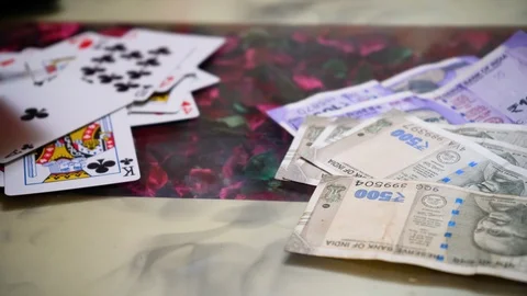 Playing cards being placed on a table as part of a gambling game with indian Stock Footage 123113860