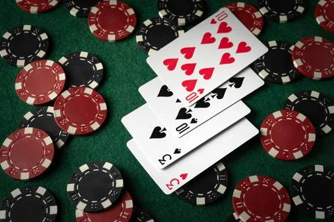 Playing cards with a combination of two pairs on a green table between many.. Stock Photos