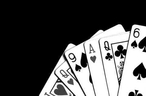 Playing cards on a dark surface close up. Black and white Stock Photos