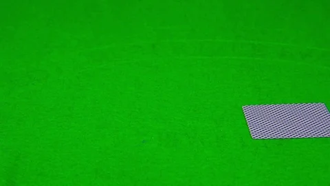 Playing cards falling on green table 動画素材 70435333