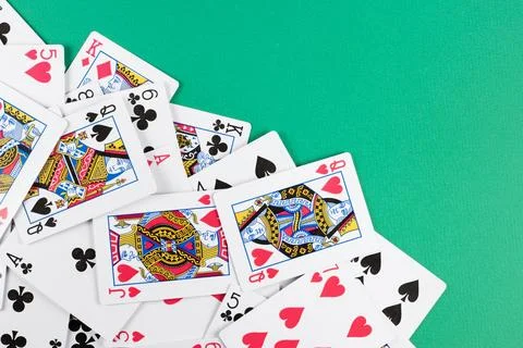 Playing cards on green background. Stock-Fotos