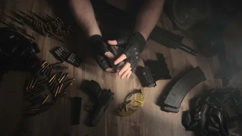 Playing cards. A mountain of weapons. High stakes. Stock Footage 230940215