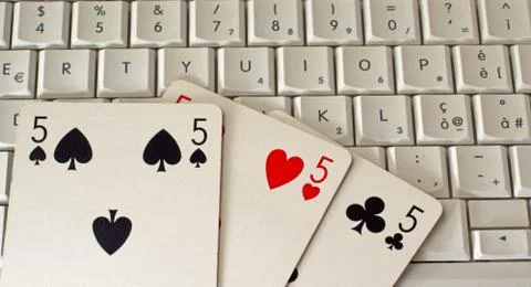 Playing cards over pc Stock Photos