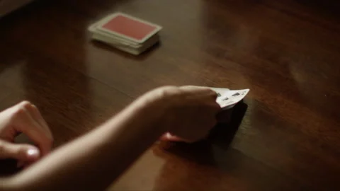 Playing cards at the table, hands with playing cards, close-up Stock Footage 230950316