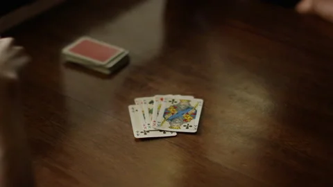 Playing cards at the table, hands with playing cards, close-up Stock Footage 230950376