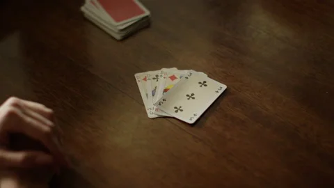 Playing cards at the table, hands with playing cards, close-up Stock Footage 230950554