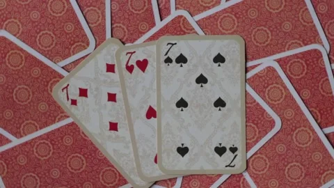 Playing cards three sevens close-up, rotate counterclockwise Stock Footage 136675744