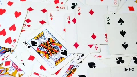 Playing cards onto a white surface background 4K Stock Footage 306949505