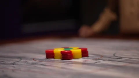 Playing carrom board with red yellow green flick disks Stock Footage 246997785