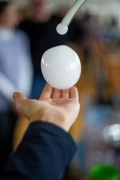 Playing with chemistry to create a bubble in hand during an experiment at a.. 스톡 사진