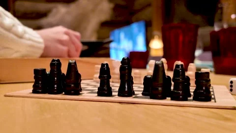 Playing Chess in Cozy Café During Winter. Relaxed indoor lifestyle with warm Stock Footage 341703128