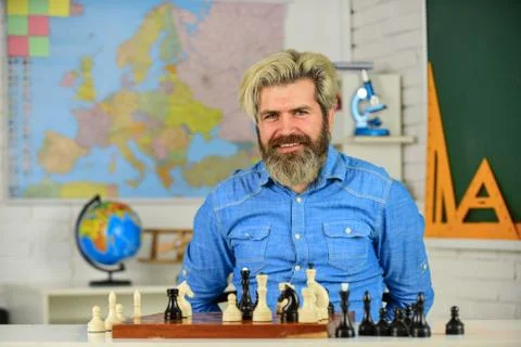 Playing chess develops brain functioning. man hold chess piece. Concentrated man Foto stock