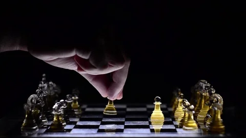 Playing chess on a lighted glass board in a dark room Stock Footage 122759166