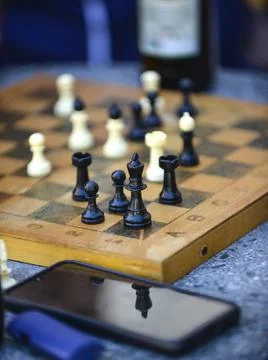Playing chess , reflection on a smartphone display Stock Photos