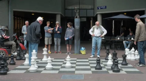 Playing chess on a square in Amsterdam Stock Footage 64876107