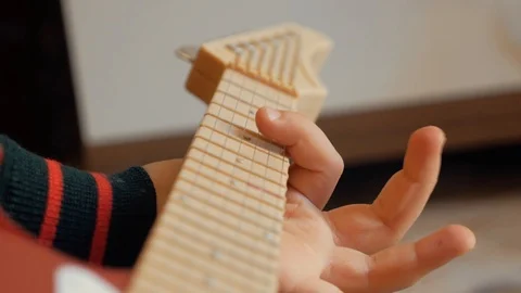Playing the children's guitar Stock Footage 87198693