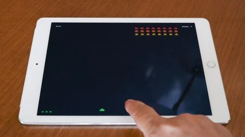 Playing a classic retro arcade game on Apple Ipad Stock Footage 114327984