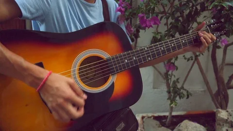 Playing the classic string guitar outside Stock Footage 128918637