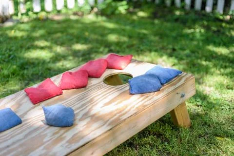 Playing cornhole in backyard Stock Photos