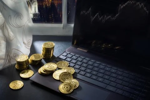 Playing with cryptocurrency: stacks of bitcoins on the table near PC, New York 스톡 사진