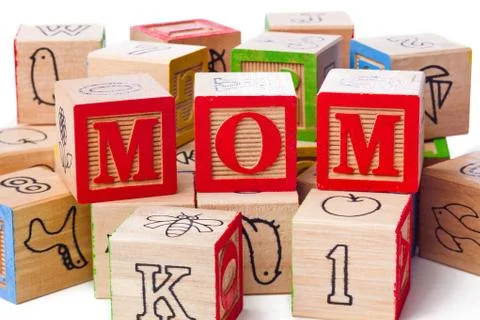 Playing cubes arranged side by side to form a word mom Stock Photos