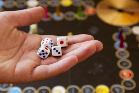Playing dice in hand against Stock Photos