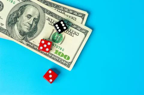 Playing Dices and Stack of American Dollars Bills Stock Photos
