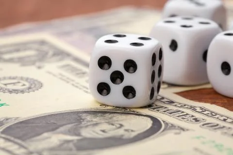Playing Dices and Stack of American Dollars Bills. Stock Photos