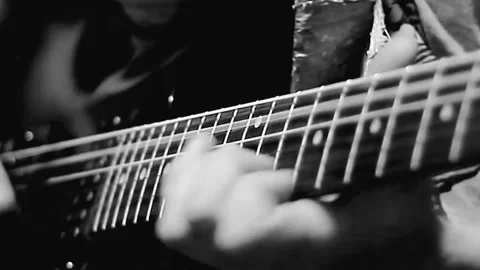 Playing electric guitar with pick making rock music with people stock Видео 332803575