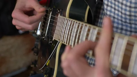 Playing electro guitar, close up of make hands playing electro guitar at home Stock Footage 149257806