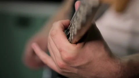 Playing the electro guitar. Macro shooting of the guitar strings and fingers 動画素材 142876753