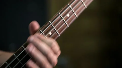 Playing the electro guitar. Macro shooting of the guitar strings and fingers Stock Footage 142878075