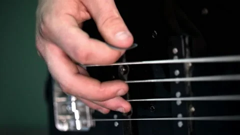 Playing the electro guitar. Macro shooting of the guitar strings and fingers Stock Footage 142890661