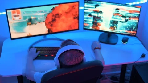 Playing esport game on computer at home at night Stock Footage 122506905